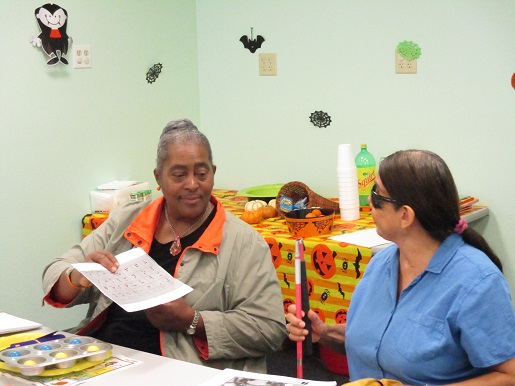 Miss Lolita and Mary are enjoying the Braille Club.